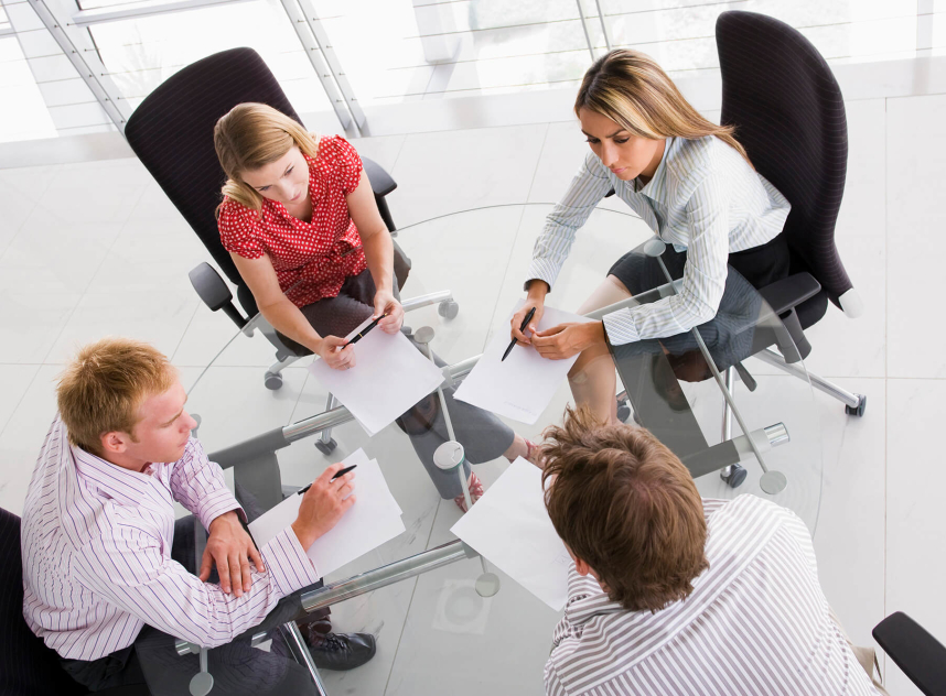 four-businesspeople-in-a-boardroom-with-paperwork-PC4V8H4 (1)-min